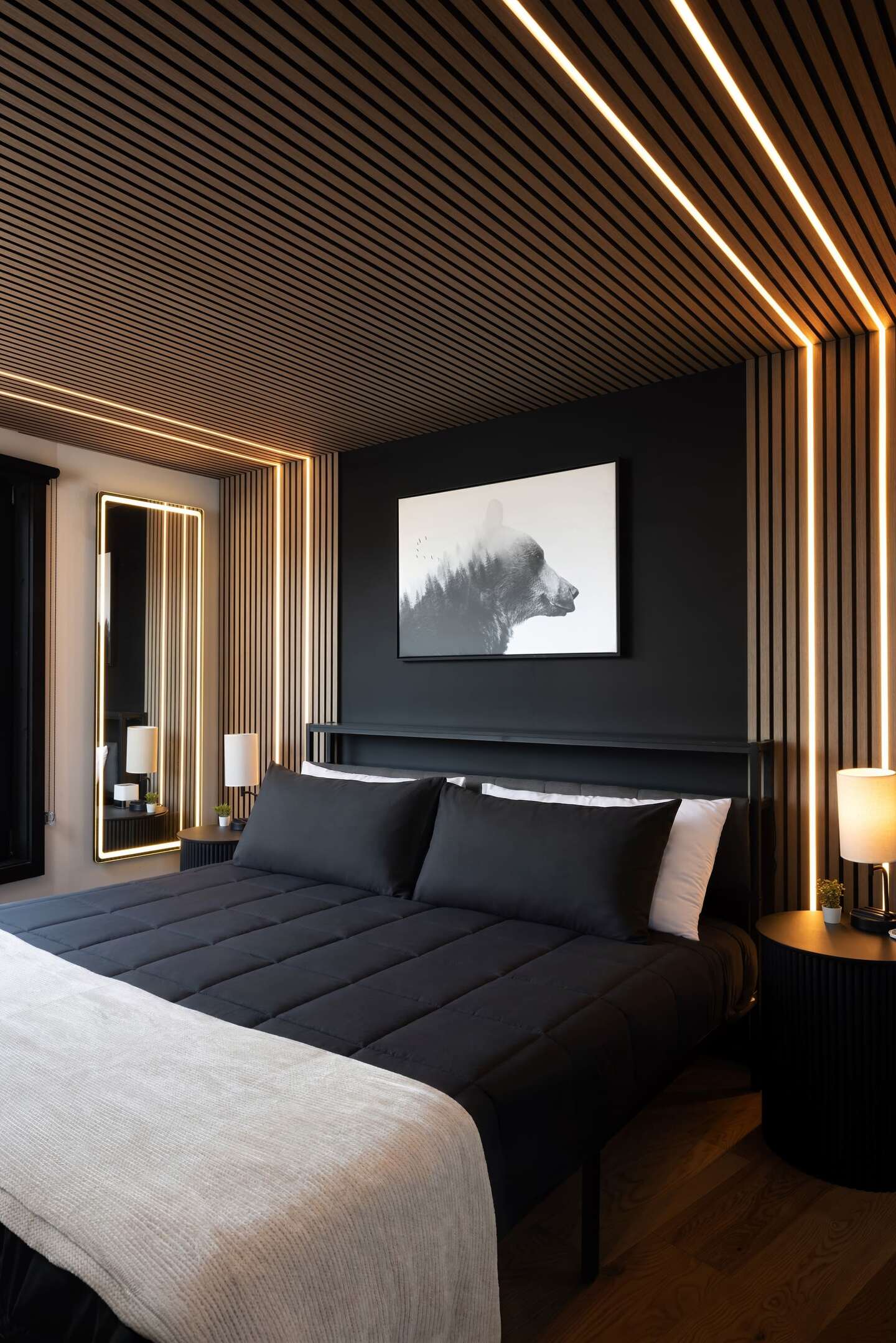 A king bedroom at Luray with slatted timber walls
